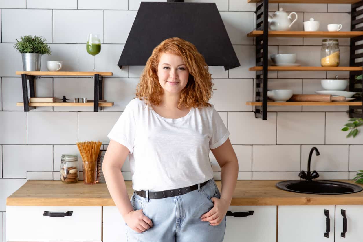 Portrait of a beautiful woman in kitchen 3 stages of bariatric surgery