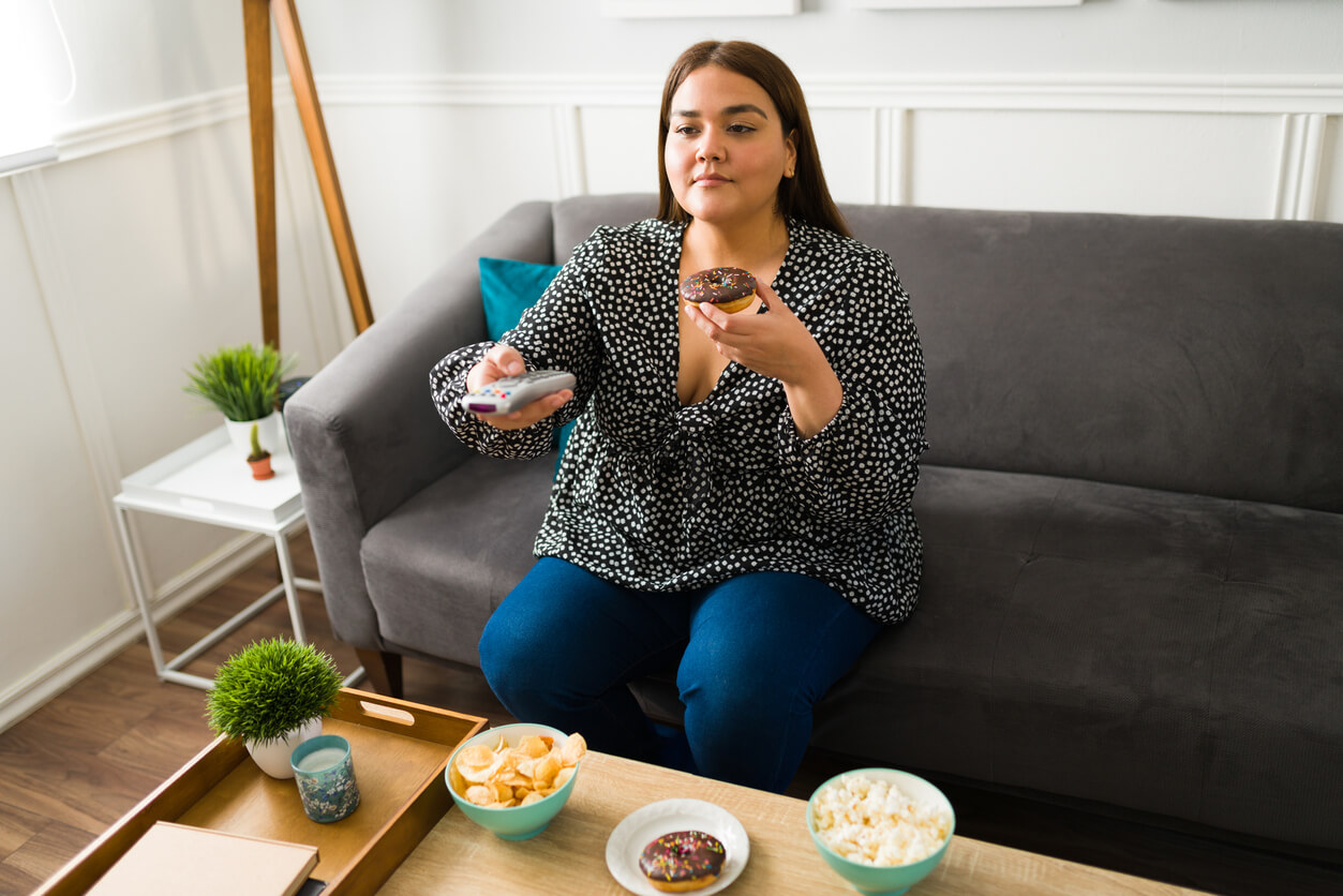 Young fat woman eating unhealthy food Prof Michael Talbot