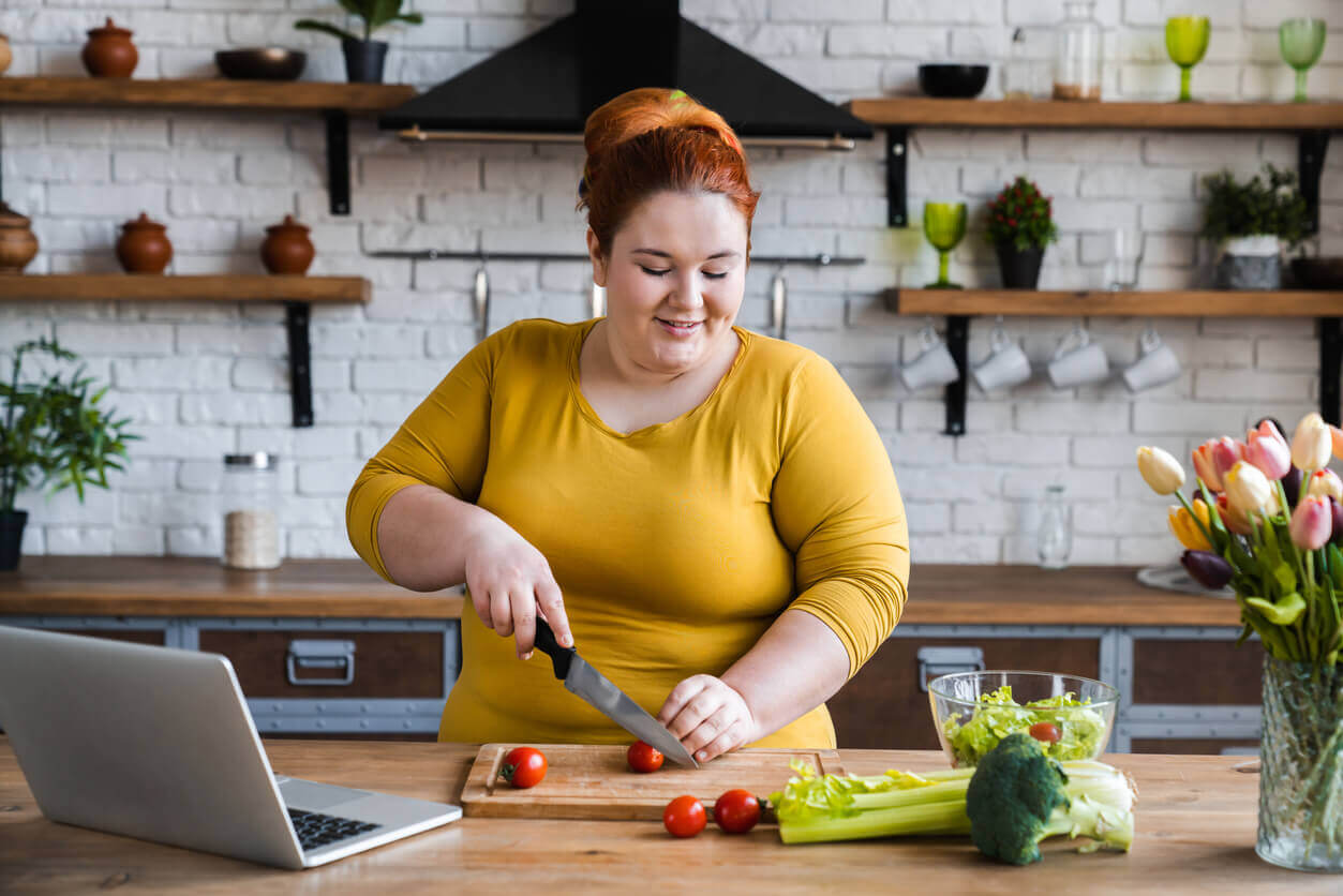 woman cooking in kitchen with laptop Prof Michael Talbot